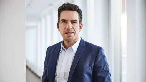 Exporo CEO Simon Brunke vor dem Hintergrund eines Büroflurs