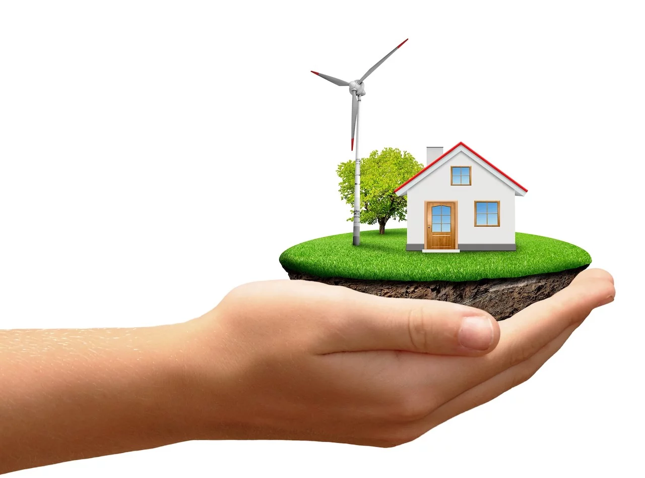 Das Haus mit dem Windrad in der Hand