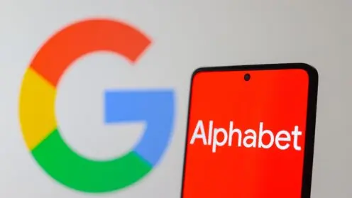 Smarthone mit rotem Display und weissem Alphabet-Logo, hinten verschwommen das Google-Logo