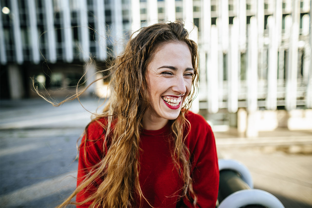 Portrait of happy young woman in the city