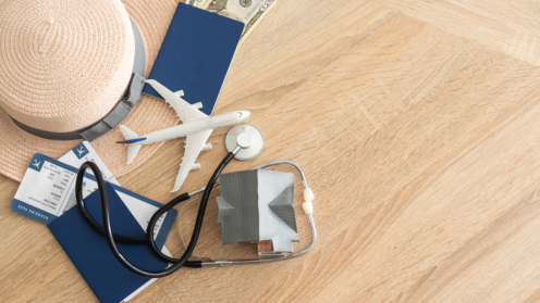 Ein Miniatur Flugzeug ein Stethoskop, eine Maske auf einem Holztisch