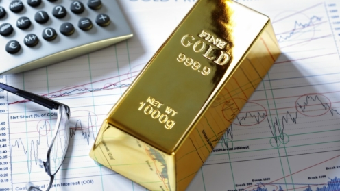 Goldbarren auf einem Aktien- und Aktienchart
